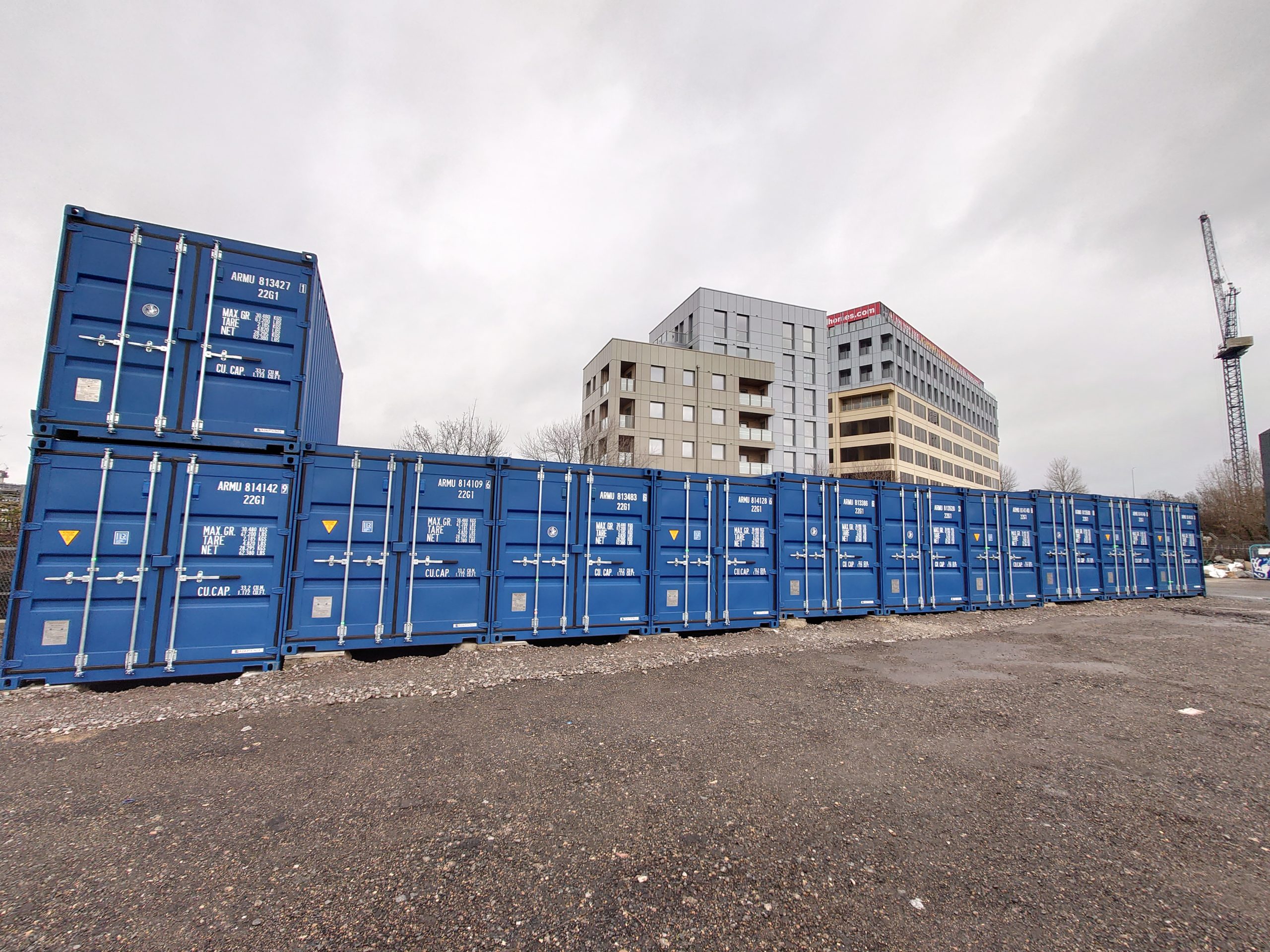 Rows of blue shipping storage containers at an outdoor storage facility